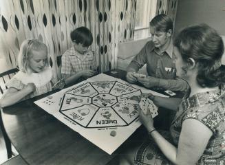 A relaxing evening. playing cards is enjoyed by Mr. and Mrs. Ted Daglish with their children Laurie, 7, and David, 10. Laurie suffers from severe alle(...)