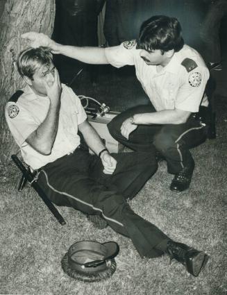 To the rescue: Dick Darrell's photo of PC John Pecsenye suffering from smoke inhalation, as PC Steve Summerville gives assistance, won the Star's photographer a Metro Police award