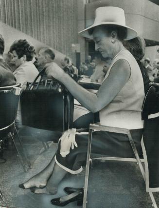 With her shoes off, East York Mayor True Davidson prepares to settle down and relax at yesterday's session of the provincial-municipal conference at t(...)