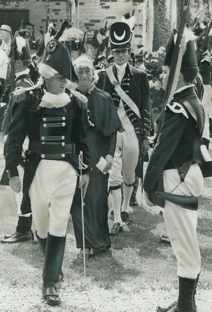 East York Mayor True Davidson, wearing a long green gown supposedly symbolizing the Spirit of the Don, walks beside Major Michael Stevenson (left), of(...)