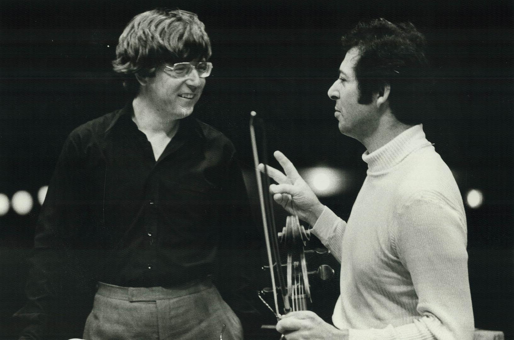 Conductor Andrew Davis confers with cellist Domb