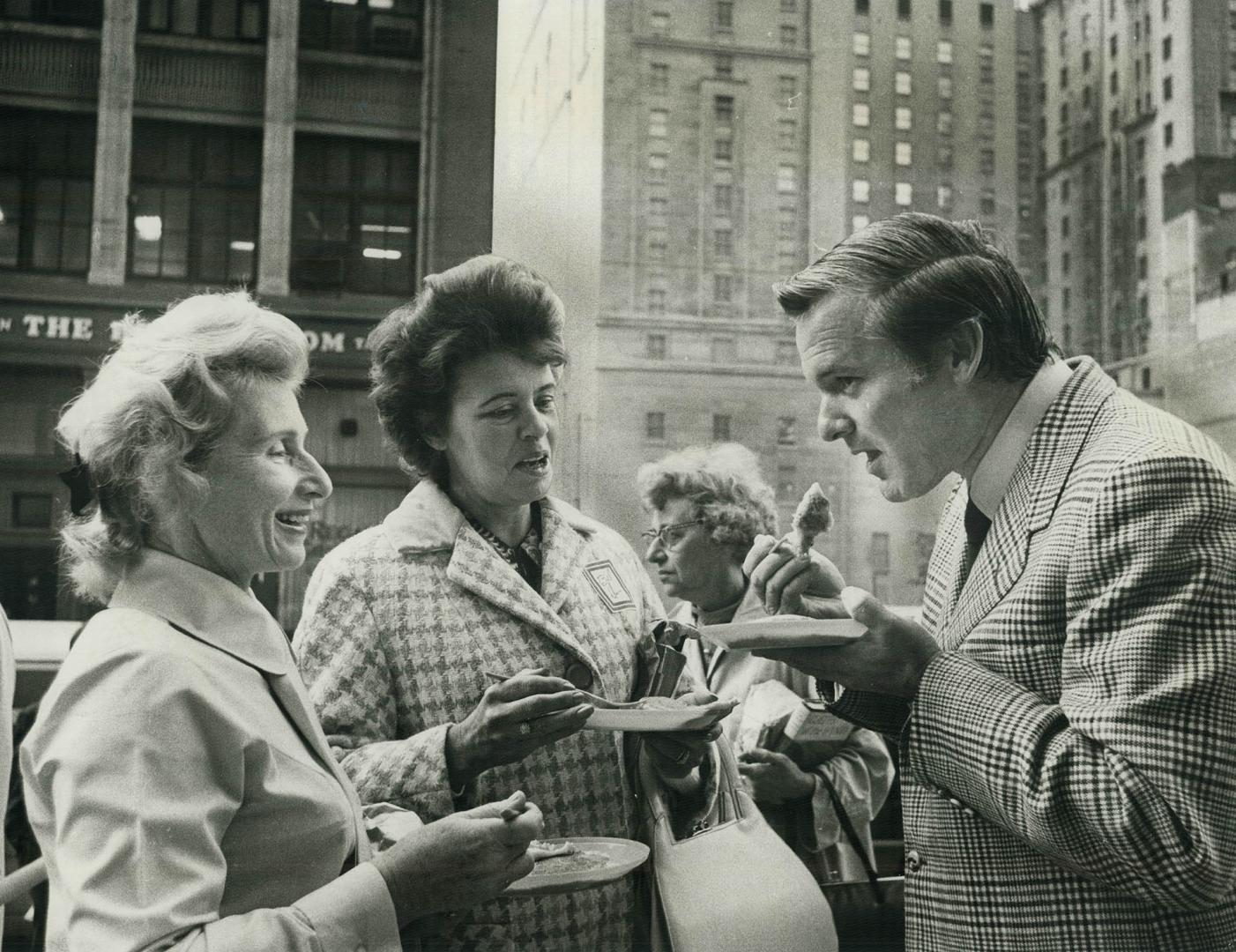 Premier William Davis grabs a quick snack in downtown Toronto this week with Mrs