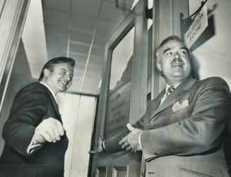 Looking over new office, Education Minister William Davis (left) is ushered into the premier's suite at Queen's Park yesterday by retiring Premier Joh(...)