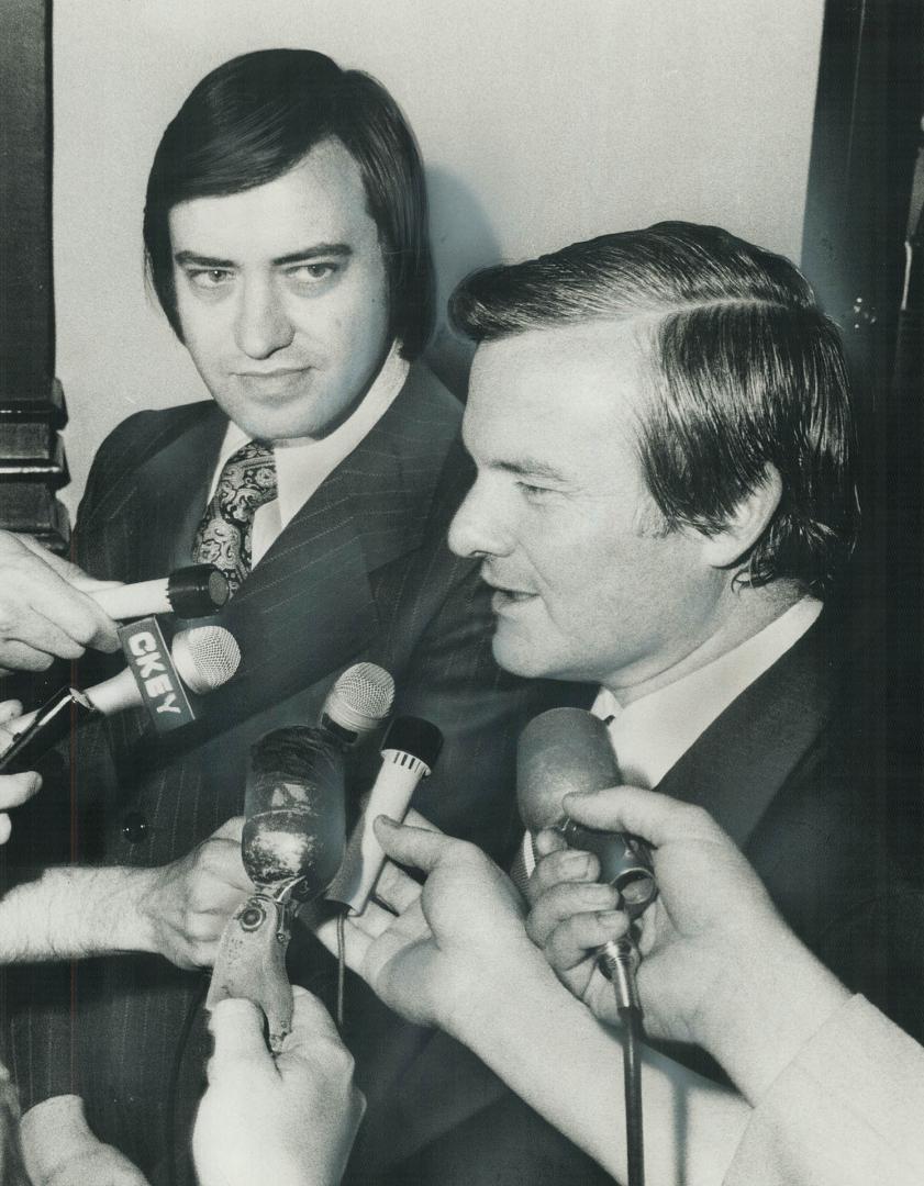 Acting metro chairman Paul Godfrey (left) and Premier William Davis talk with reporters yesterday after their private conference at Queen's Park. Godf(...)