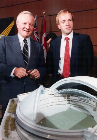 Proud moment: Bill Davis and Chuck Magwood, president of the Stadium Corporation, show off the seashell design picked in 1985