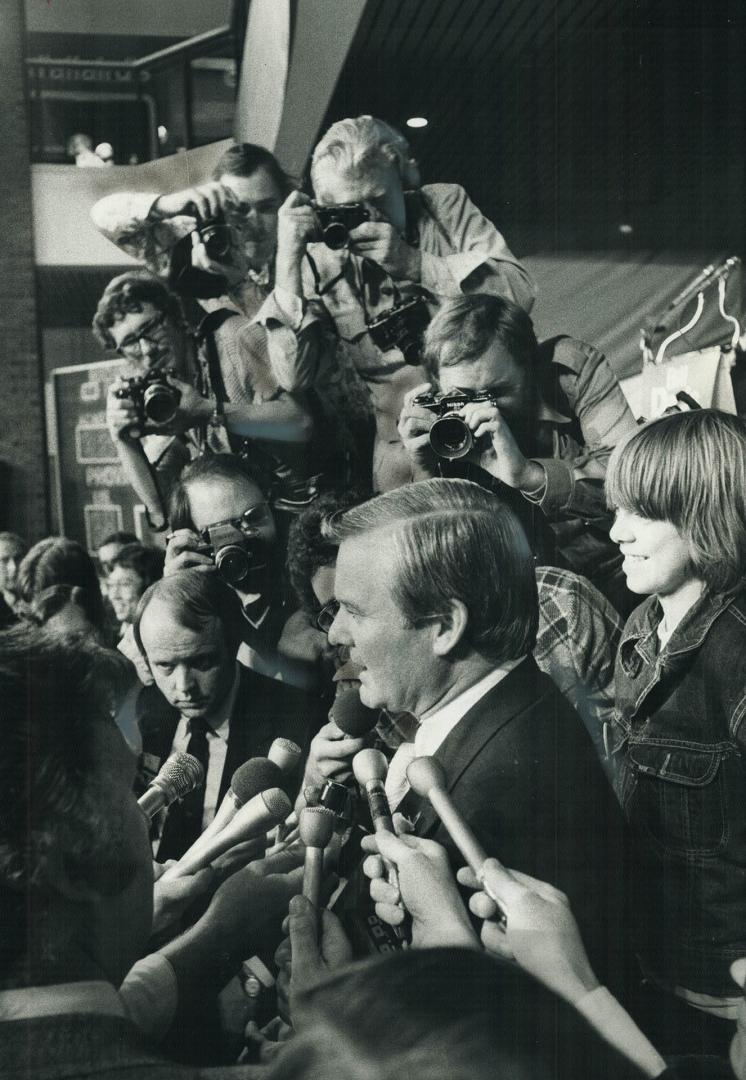 Shooting the Premier: William Davis, almost swamped by photographers, above, is also under fire from readers who object to his calling the election in which he again failed to win a majority