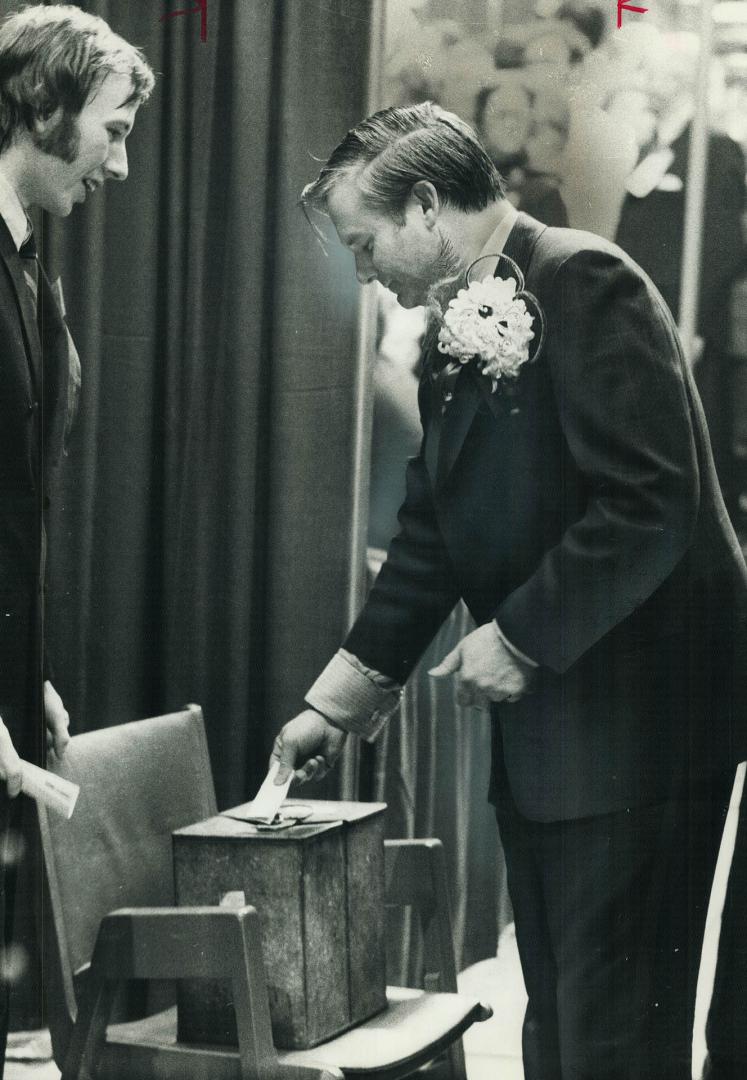 Casting his vote last night at Maple Leaf Gardens, Ontario Education Minister William Davis, now premier-designate of Ontario, places his ballot carefully in box