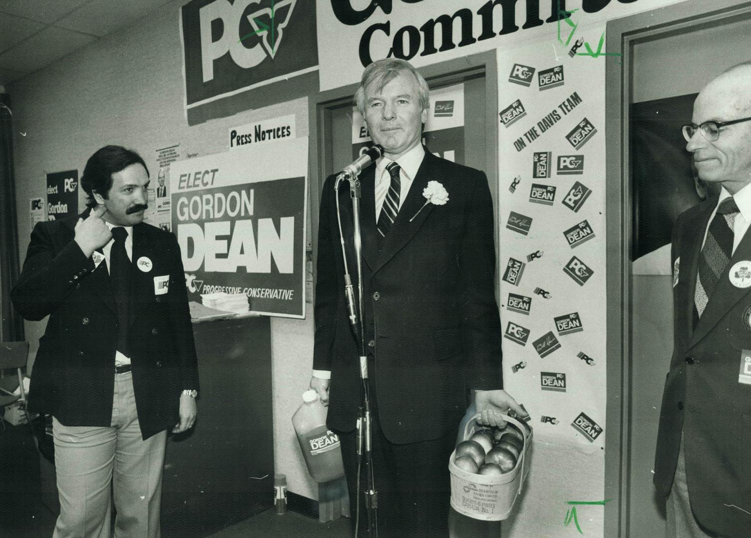 Home-grown: Premier William Davis took to heart the television commercial that says good things grow in Ontario and picked up a basket of apples yesterday while campaigning in Wentworth riding