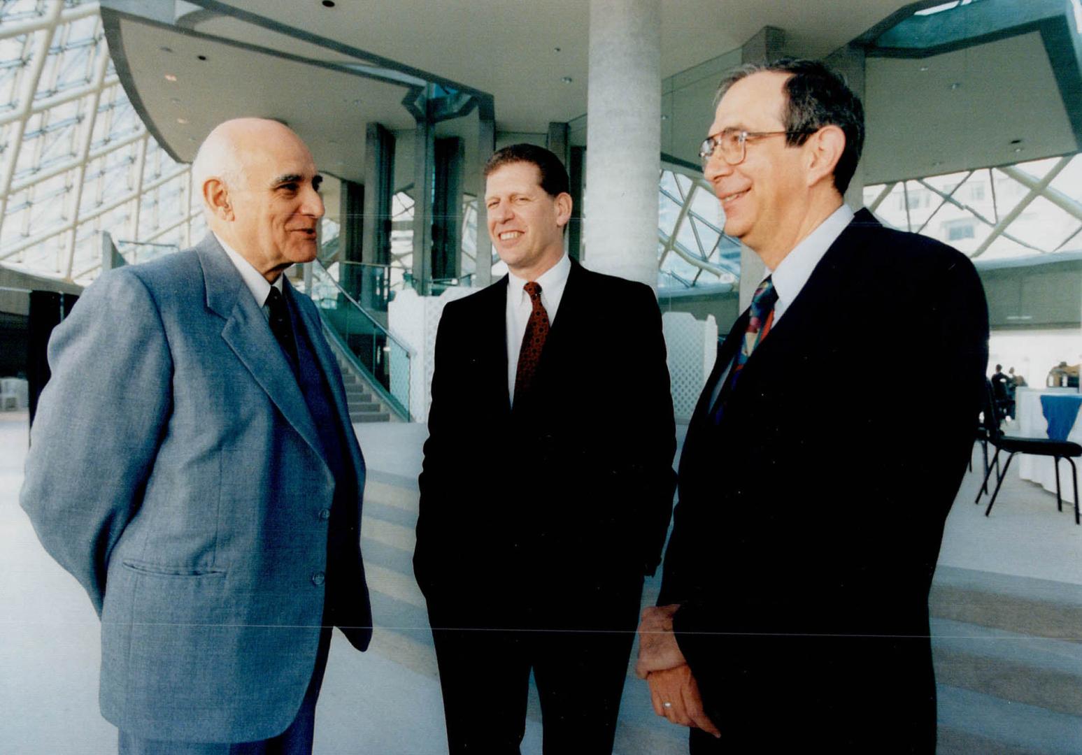 Ian Delaney speaks to assembled, and after meeting chats with Cuban Ambassador, Bienvenido Garcia (blue suit) and Cuba's Minister of Finance Manuel Millares (grey suit)