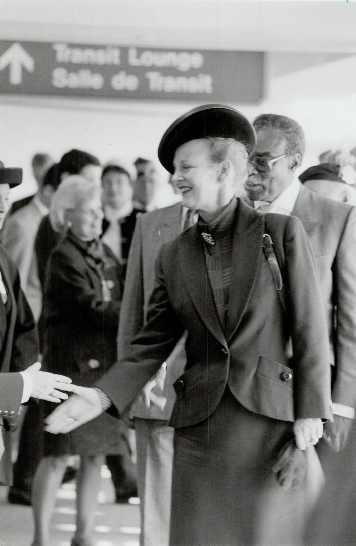 The Royal touch. Queen Margrethe II of Denmark greets well-wishers at Pearson International Airport yesterday, tralled by Ontario Lieutenant-Governor (...)