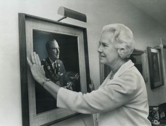 Mrs. Dennison, called Dodo by her husband, admires his picture in the home she's decorated with a collection of 19th-century artifacts