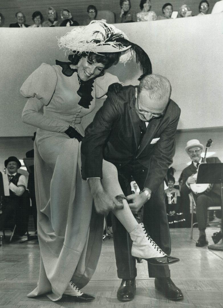 A mayor of the garter. Mayor William Dennison performs the Klondike Garter ceremony by taking the garter off the leg of Norma Chapman of the Klondike (...)