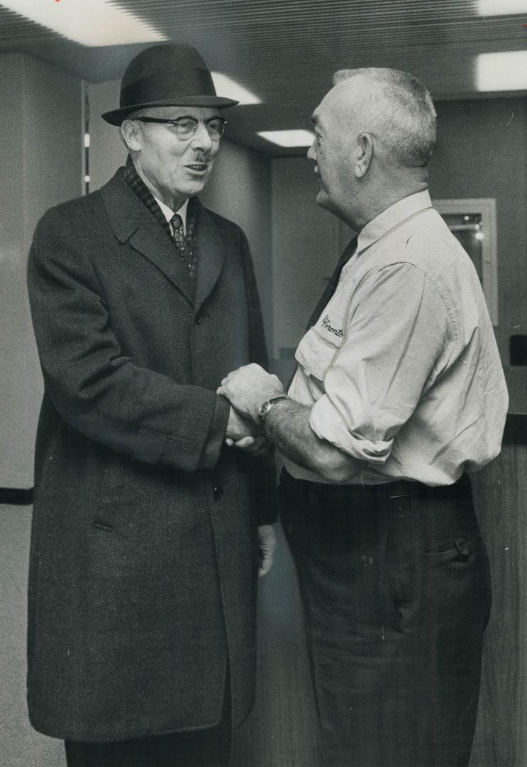 Mayor-elect William Dennison is congratulated by Jack Barnes, sergeant-at-arms in City Hall, as the former controller arrives at his office today. Tha(...)