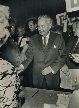 A big hello is given registration desk workers by John Diefenbaker as the Progressive Conservative leader arrives at the Royal York today for the part(...)