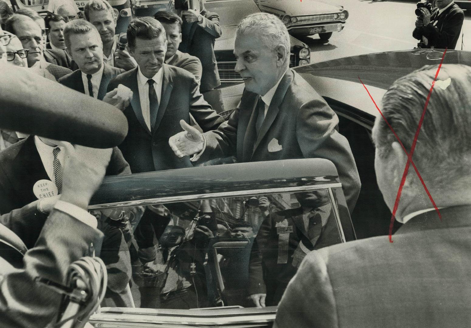 The Chief's supporters crowd around Diefenbaker's limousine as he arrives at Royal York Hotel today for Conservative leadership convention. A Scottish(...)