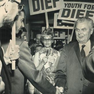 Greeting Wellwishers with a warm handshake, John Diefenbaker emerges from his Royal York Hotel suite after allowing his name to be entered as a candid(...)