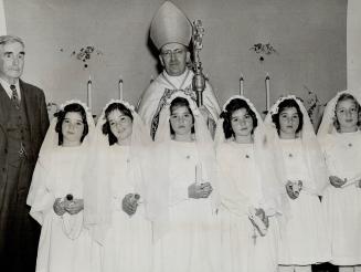 The Dionne quintuplets' nursery at Callander was a flower - decked chapel for the confirmation of the five famous sisters by Brig. C.L. Nelligan, chie(...)