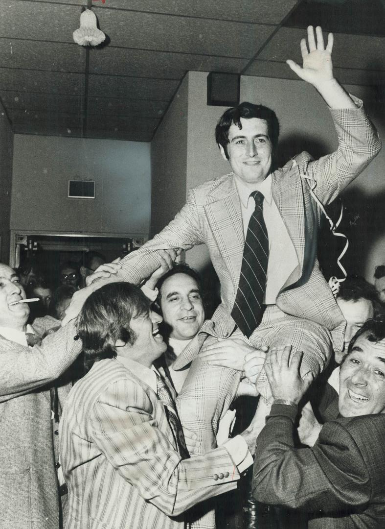 Dr. Martin Dobkin, 31, a newcomer to politics who was elected mayor of the new City of Mississauga last night, is lifted on the shoulders of supporter(...)