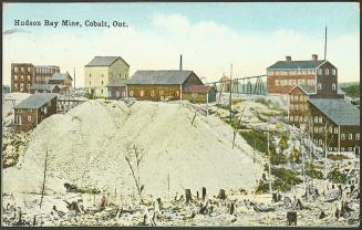 Several industrial buildings on top a of rocky hill.