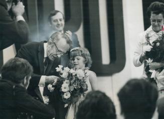 Retiring NDP leader Tommy Douglas receives flowers from Sandra Fawlkner, 6