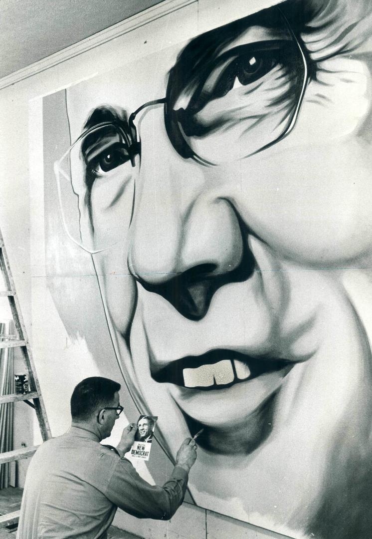 Artist Joe Franken works on section of 20' x 14' painting of five-foot-five NDP Leader T