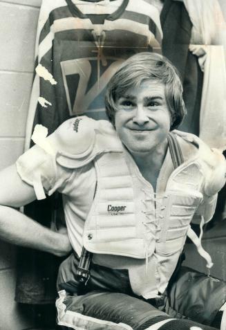 A different role. Ken Dryden, former all-star Montreal Canadiens' goalie puts on gear before going on ice yesterday at New Toronto Memorial Arena as defenceman for Vulcan Industrial