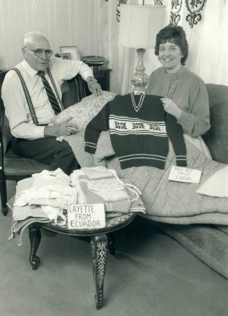 Layettes from Ecuador. Murray Dryden, co-founder of Sleeping Children Around the World, and volunteer co-ordinator Laurie-Beth Davidson display some of the items they send in their bed kits