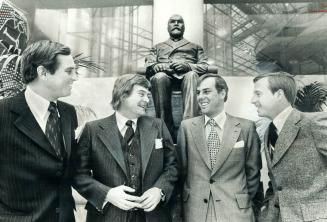 In front of statue of Timothy Eaton, the store's founder, the Eaton brothers discuss their store's future