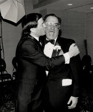 So long, Johnny. Revenue minister and former world skating champion Otto Jelinek plants one on Johnny Esaw's cheek at dinner last night honoring the b(...)