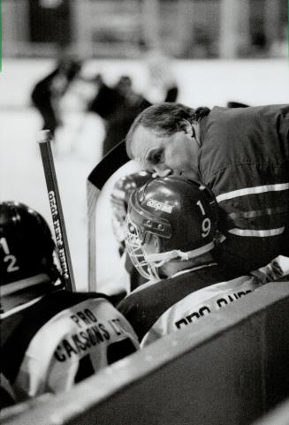 Expert advice: Ron Ellis, assistant coach with the Brampton Capitals, shares his expertise with a player during opening game of junior A Classic tournament