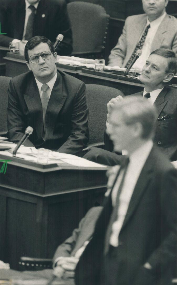 Continuing to come under fire, Premier Bob Rae, right, faced a hostile opposition yesterday calling for Solicitor-General Mike Farnan to step aside while police probe controversial letters