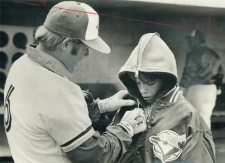 The Jays' Senior Citizen, 38-year-old infielder Ron Fairly, gives a few warm-up instructions to his son, Mike, 11, during team's workout yesterday. To(...)