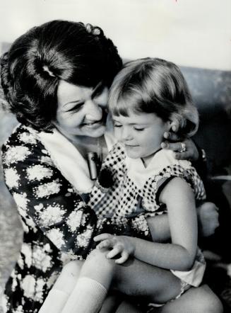 Four-year-old Carrie is hugged by Mary Feldstein yesterday, after the Feldsteins, who are her adoptive parents, were awarded custody of the child. An (...)