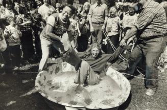 Making waves. Susan Fish gets dunked in a wading pool with an assist from Ying Hope as the two aldermen finish a tug-of-war at the Annex fall fair yes(...)