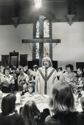 Communion at Trinity. Rev. James Fisk of Holy Trinity Church, Trinity Square, stands at the altar as he blesses bread and wine for those who attended the Easter communion service yesterday