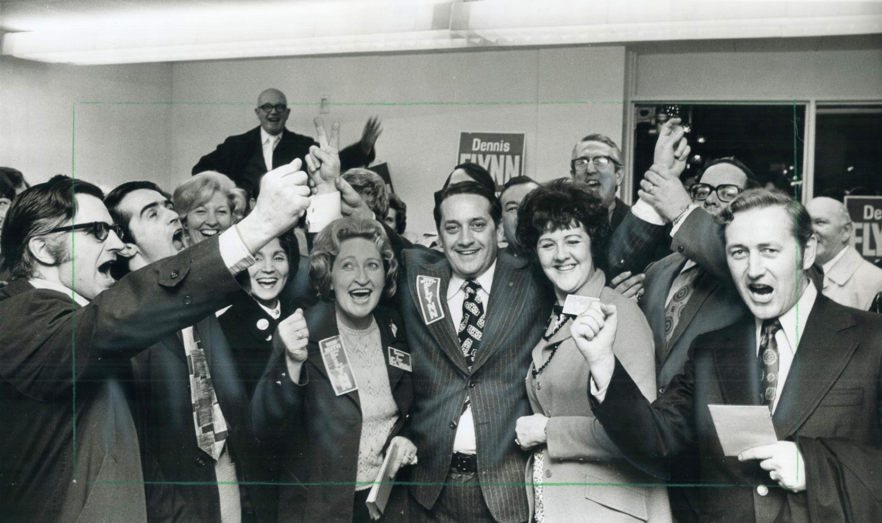 Elected Mayor of Etobicoke for second time in four months, Dennis Flynn has his arms upraised in victory by jubilant campaign workers last night in hi(...)