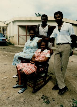 Tony Fernandez family in front of their new home in San Pedro L-R, Brothers Jose, 22, Manuel, 25 mother Andrea, 62 and sister