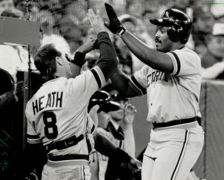 Anything you can do . . . Kelly Gruber, left, had a pair of homers for the Blue Jays but ex-Jay Cecil Fielder countered with three of his own for the Tigers at SkyDome yesterday