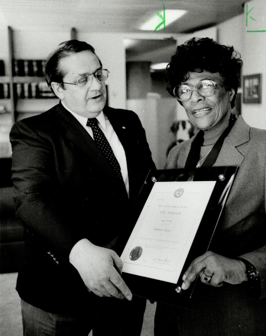 A tribute to Ella. Metro Chairman Dennis Flynn admires a plaque presented to Ella Fitzgerald at city hall yesterday, where Mayor Art Eggleton declared(...)