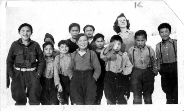 Children posing with teacher