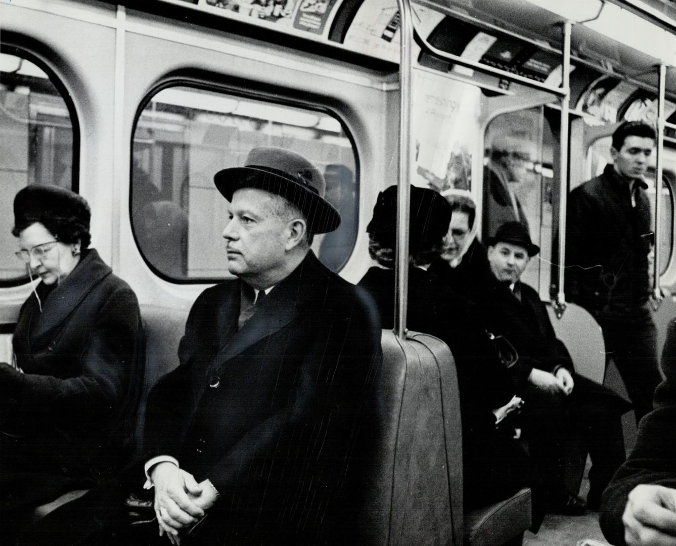 A face in crowd. Former finance minister Donald Fleming goes unrecognized in crowd on Yonge St. subway. He take subway to law office and home to avoid battling traffic