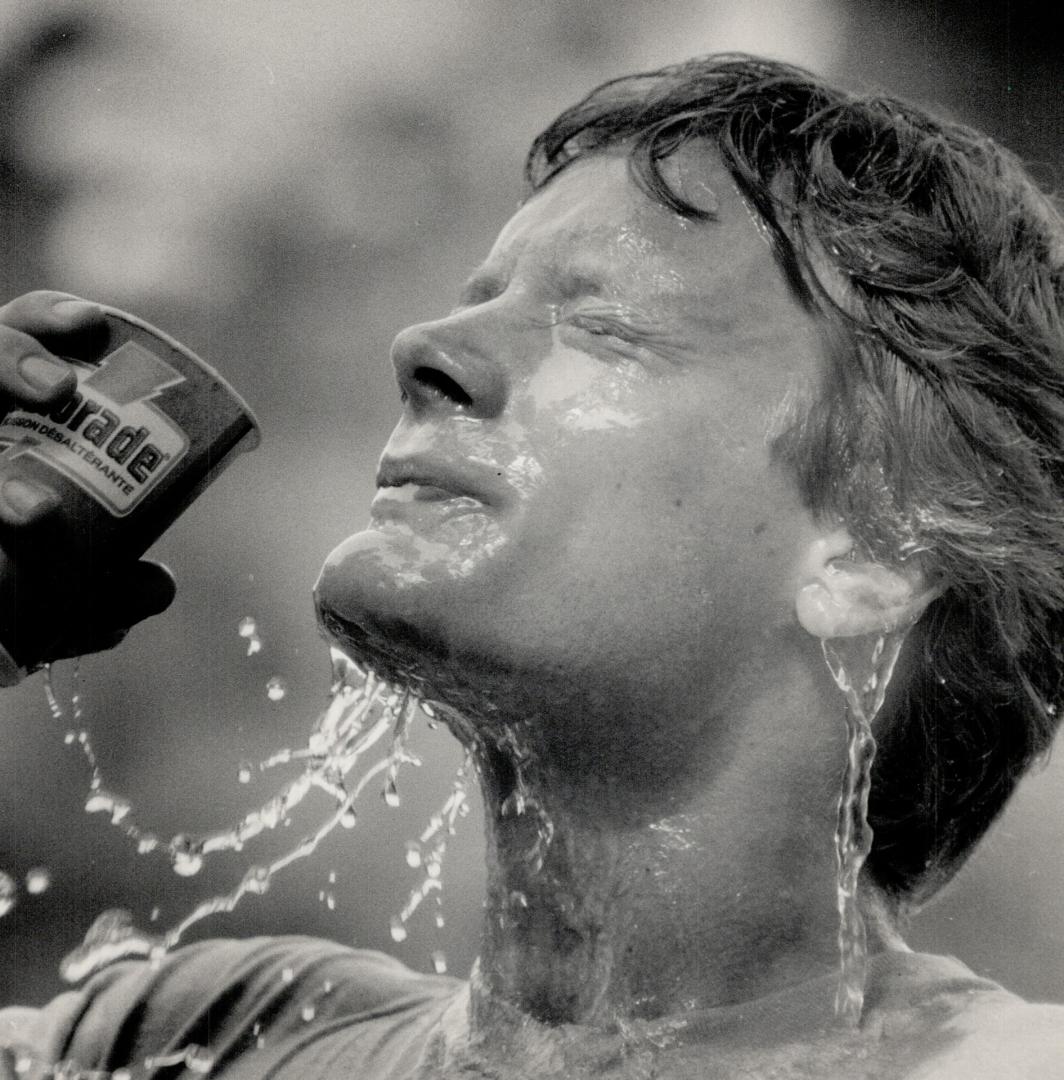 Job well done: Deter Stymest douses himself after the 10-kilometre Terry Fox Run, named for the one-legged athlete who ran halfway across Canada to raise cancer research funds