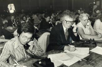 Ken Taylor, takes pledges while Darryl Sittler gives Lynn Burbe his autograph