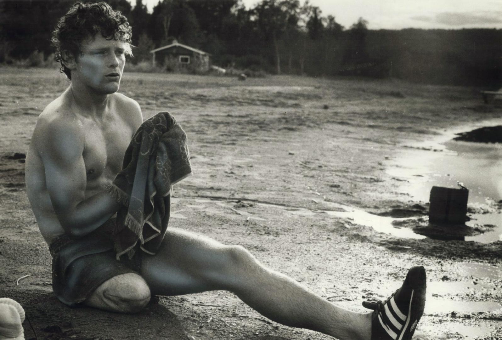 A weary Terry Fox pauses to wipe his face in northern Ontario, on the epic run which ended with his final collapse soon after