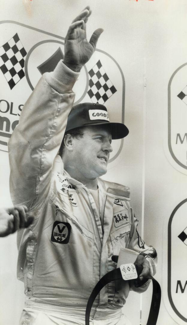 A winner's wave: A. J. Foyt accepts the cheers of the throng at Mosport Park yesterday after he captured the Molson Indy race and the $26,400 prize that goes with it