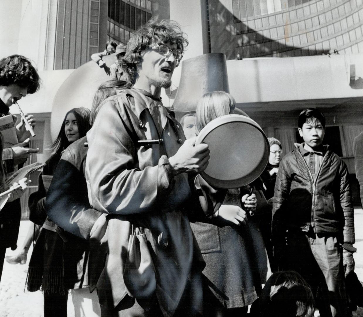 Just doing his thing, Vancouver town fool Jochim Foikis beats drum in front of City Hall Saturday