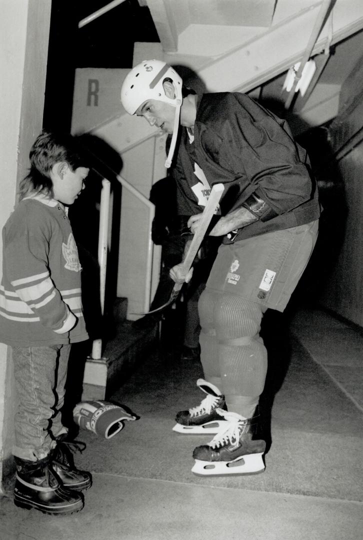 Excellent strickhandling: Five-year-old Creighton Reid of Milton gets Foligno's autograph on a stick during visit to Maple leafs practice