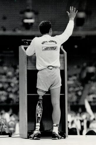 Triumphant runner: One-legged runner Steve Fonyo waves to a cheering crowd in Vancouver before starting his speech at the conclusion of his cross-Canada Journey For Lives in May