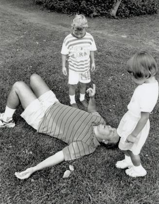 Done in: Bemused youngsters Courtney Rose, 3, and Kenneth Ricardo, 5, come to the aid of exhausted runner Richard Silva