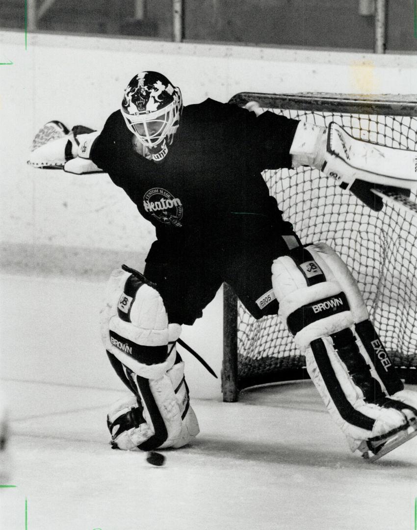 Fun and Games: Leafs Lucien DeBlois, left, and Mike Bullard share a laugh at practice yesterday while Grant Fuhr Kicks out for a save